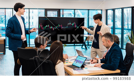 Two young worker leading business meeting about cryptocurrencies in an office Two young worker leading business meeting about cryptocurrencies in an office 99183988