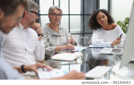 discussion of business people in the office sitting at the table 99184043