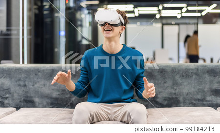 An excited young man exploring virtual reality 99184213