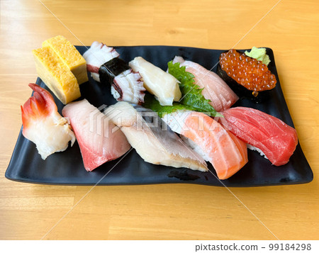 The premium Japanese sushi set place on black plate with wasabi The premium Japanese sushi set place on black plate with wasabi 99184298