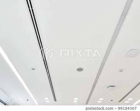Ceiling mounted cassette type air conditioner and modern lamp light on white ceiling. duct air conditioner for home or office 99184307