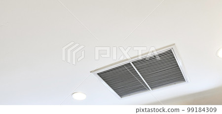 Ceiling mounted cassette type air conditioner and modern lamp light on white ceiling. duct air conditioner for home or office Ceiling mounted cassette type air conditioner and modern lamp light on white ceiling. duct air conditioner for home or office 99184309