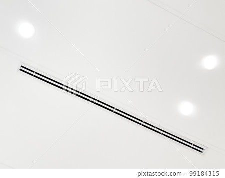 Ceiling mounted cassette type air conditioner and modern lamp light on white ceiling. duct air conditioner for home or office Ceiling mounted cassette type air conditioner and modern lamp light on white ceiling. duct air conditioner for home or office 99184315