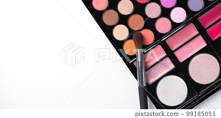 Multi colored eye shadow palette with brush top view. Abstract beauty background with eye shadows and blusher. 99185051