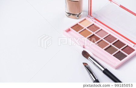 Beige eye shadow palette with brush on white background. Decorative cosmetics. Beauty products. Nude brown eye shadow. 99185053