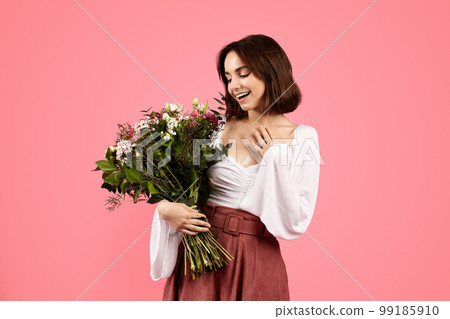 Its for me. Glad surprised young european woman enjoy gift, bouquet of white tulips, rejoice spring holiday 99185910