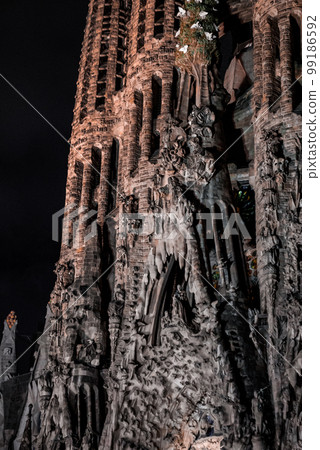 Night view of the La Sagrada Familia cathedral. Impressive cathedral designed and unfinished by Gaudi in the center of Barcelona. Night view of the La Sagrada Familia cathedral. Impressive cathedral designed and unfinished by Gaudi in the center of Barcelona. 99186592