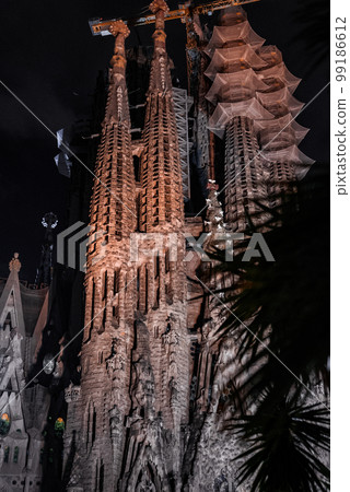 Night view of the La Sagrada Familia cathedral. Impressive cathedral designed and unfinished by Gaudi in the center of Barcelona. Night view of the La Sagrada Familia cathedral. Impressive cathedral designed and unfinished by Gaudi in the center of Barcelona. 99186612