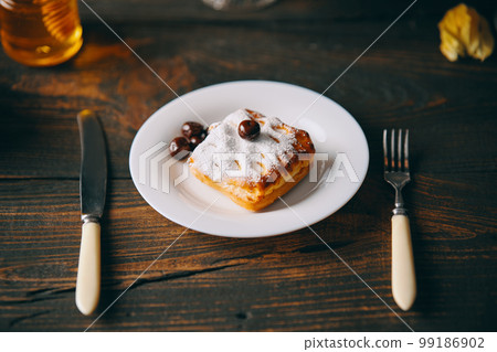 Homemade cherry pastries on plate over dark wooden background. Homemade cherry pastries on plate over dark wooden background. 99186902