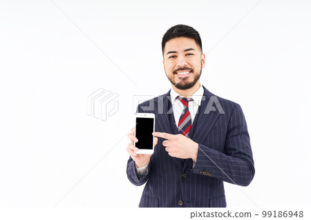 A man in a suit with a smartphone A man in a suit with a smartphone 99186948