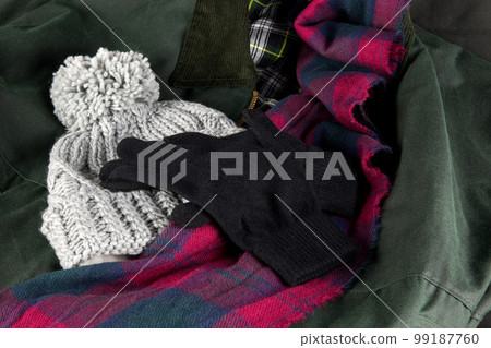 Woollen Bobble Hat with Scarf and Gloves on an Outdoor Coat Woollen Bobble Hat with Scarf and Gloves on an Outdoor Coat 99187760