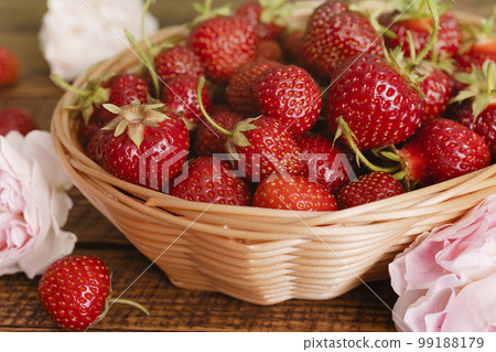 Ripe garden strawberry in bowl on wooden table Ripe garden strawberry in bowl on wooden table 99188179