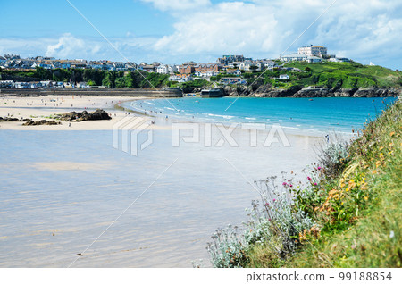 Beautiful Newquay beach with blue sea, stone cliffs and white sand in Cornwall, south west England, selective focus 99188854