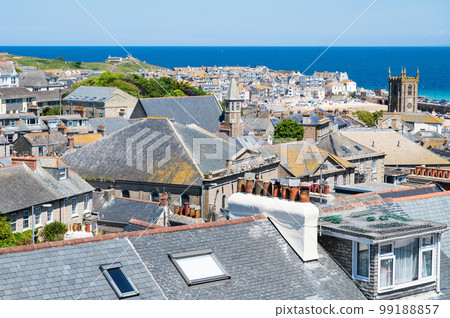 View of rooftops in St Ives, west Cornwall, South West England. Beautiful blue sea on the background. Selective focus View of rooftops in St Ives, west Cornwall, South West England. Beautiful blue sea on the background. Selective focus 99188857