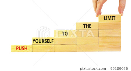 Push the limit symbol. Concept words Push yourself to the limit on wooden blocks. Beautiful white table white background. Businessman hand. Business push the limit concept. Copy space. Push the limit symbol. Concept words Push yourself to the limit on wooden blocks. Beautiful white table white background. Businessman hand. Business push the limit concept. Copy space. 99189056