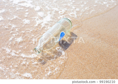 Glass bottle on the beach 99190210