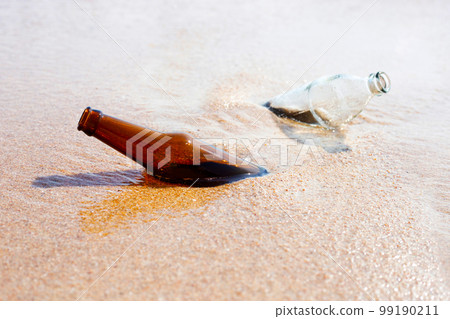 Glass bottle on the beach Glass bottle on the beach 99190211