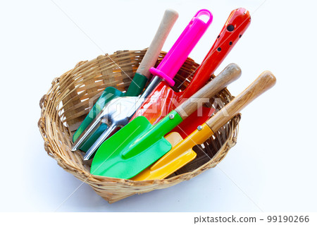 Garden shovel with fork in bamboo basket on white background. Garden tools Garden shovel with fork in bamboo basket on white background. Garden tools 99190266