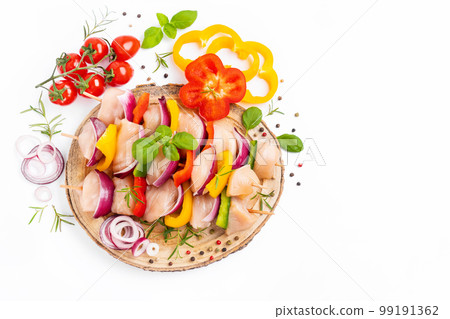 Raw chicken skewers with vegetables, peppers, onions, on a white background.Uncooked mixed meat skewer with peppers.Skewers with pieces of raw meat, red, yellow and green pepper.Top view. 99191362