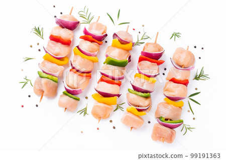 Chicken Skewers breast fillet meat.Uncooked mixed meat skewer.Skewers with pieces of raw meat,red,yellow,green pepper.Top view.Raw chicken skewers with vegetables,peppers,onions,on a white background. Chicken Skewers breast fillet meat.Uncooked mixed meat skewer.Skewers with pieces of raw meat,red,yellow,green pepper.Top view.Raw chicken skewers with vegetables,peppers,onions,on a white background. 99191363