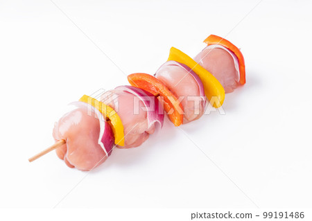 Raw chicken leg meat skewers with vegetables, peppers, onions, on a white background.Uncooked mixed meat skewer with peppers.Skewers with pieces of raw meat, red, yellow and green pepper.Top view. Raw chicken leg meat skewers with vegetables, peppers, onions, on a white background.Uncooked mixed meat skewer with peppers.Skewers with pieces of raw meat, red, yellow and green pepper.Top view. 99191486