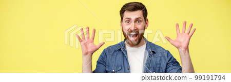 Scared man with raised his hands up and shouting sees something in front 99191794