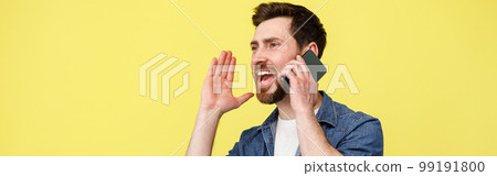 Happy man shouting loudly while talking on the phone and gesturing with his hands Happy man shouting loudly while talking on the phone and gesturing with his hands 99191800