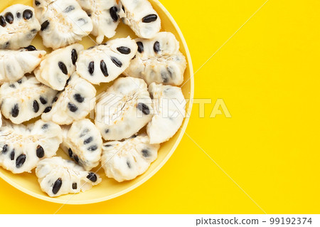 Custard apple in white plate on yellow background. Custard apple in white plate on yellow background. 99192374