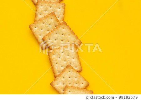 Dry cracker cookies on yellow background. 99192579