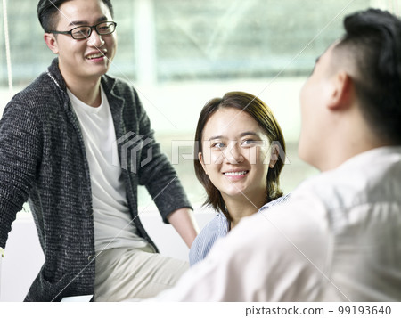 team of three asian business men and woman meeting in office 99193640