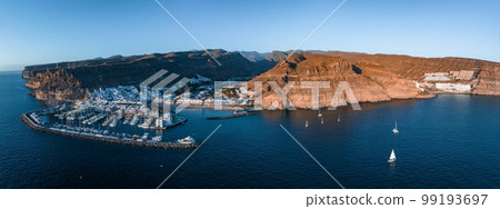 Puerto de Mogan fishing town aerial view at sunset. Traditional colorful buildings with many fishing boats at Gran Canaria, Canary Islands, Spain 99193697