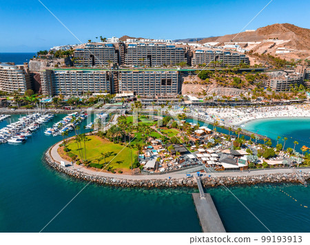 Beautiful aerial landscape with Anfi beach and resort, Gran Canaria, Spain. Luxury hotels, turquoise water, sandy beaches in Spain. Luxury beach vacation concept. Heart shaped island. Beautiful aerial landscape with Anfi beach and resort, Gran Canaria, Spain. Luxury hotels, turquoise water, sandy beaches in Spain. Luxury beach vacation concept. Heart shaped island. 99193913