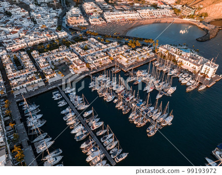 Puerto de Mogan fishing town aerial view at sunset. Traditional colorful buildings with many fishing boats at Gran Canaria, Canary Islands, Spain 99193972