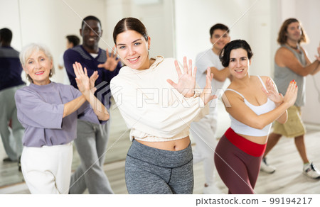 Group of people practicing energetic lindy hop movements Group of people practicing energetic lindy hop movements 99194217