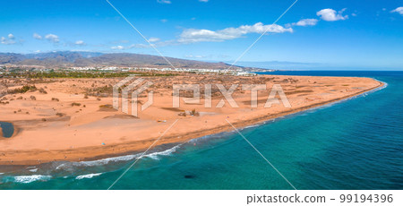 Panoramic aerial scene of the Maspalomas Dunes in Playa del Ingles, Maspalomas, Gran Canaria, Spain. Endless desert sands. Magical safari dunes. 99194396