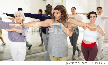 Group of dancing people practicing energetic swing 99194397