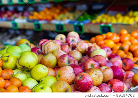 Bunches of fruits on shelves in greengrocer Bunches of fruits on shelves in greengrocer 99194708