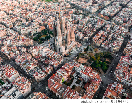 Aerial view of Barcelona City Skyline and Sagrada Familia Cathedral at sunset. Eixample residential famous urban grid. Cityscape with typical urban octagon blocks 99194752