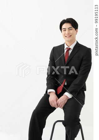 A businessman sitting in a chair 99195113