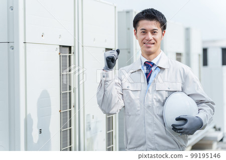 A male worker standing in front of the outdoor unit A male worker standing in front of the outdoor unit 99195146