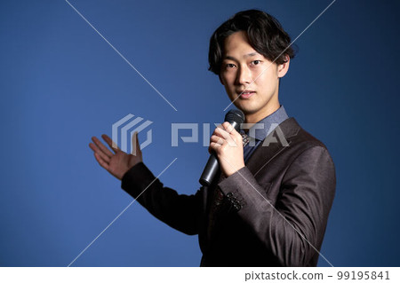 Young business person holding a microphone and giving a speech Business image 99195841