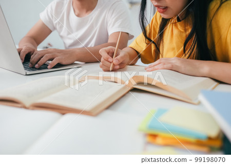 Close up an asian students are reading books and study, Tutoring together. 99198070