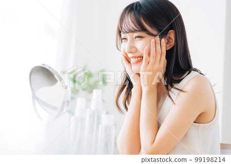 Smiling woman sipping skin care 99198214