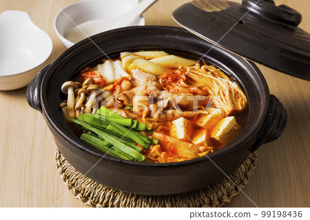 Kimchi hot pot with lots of ingredients in a black clay pot 99198436