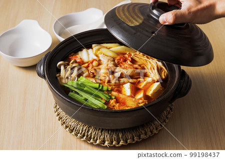Kimchi hot pot with lots of ingredients in a black clay pot 99198437