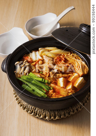 Kimchi hot pot with lots of ingredients in a black clay pot 99198444