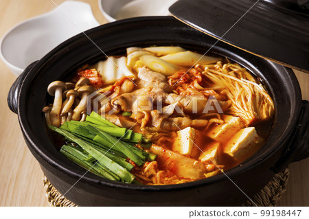Kimchi hot pot with lots of ingredients in a black clay pot 99198447