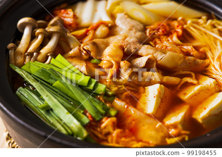 Kimchi hot pot with lots of ingredients in a black clay pot Kimchi hot pot with lots of ingredients in a black clay pot 99198455