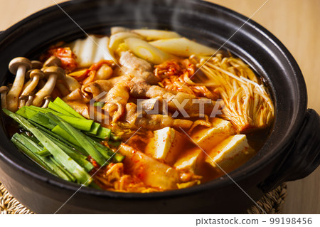 Kimchi hot pot with lots of ingredients in a black clay pot Kimchi hot pot with lots of ingredients in a black clay pot 99198456