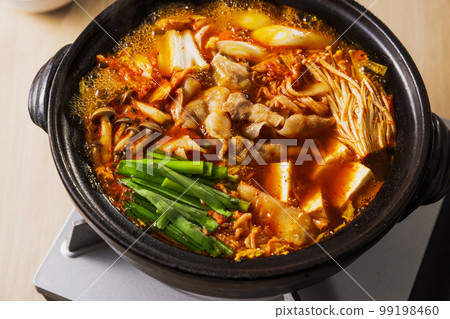Kimchi hot pot with lots of ingredients in a black clay pot Kimchi hot pot with lots of ingredients in a black clay pot 99198460
